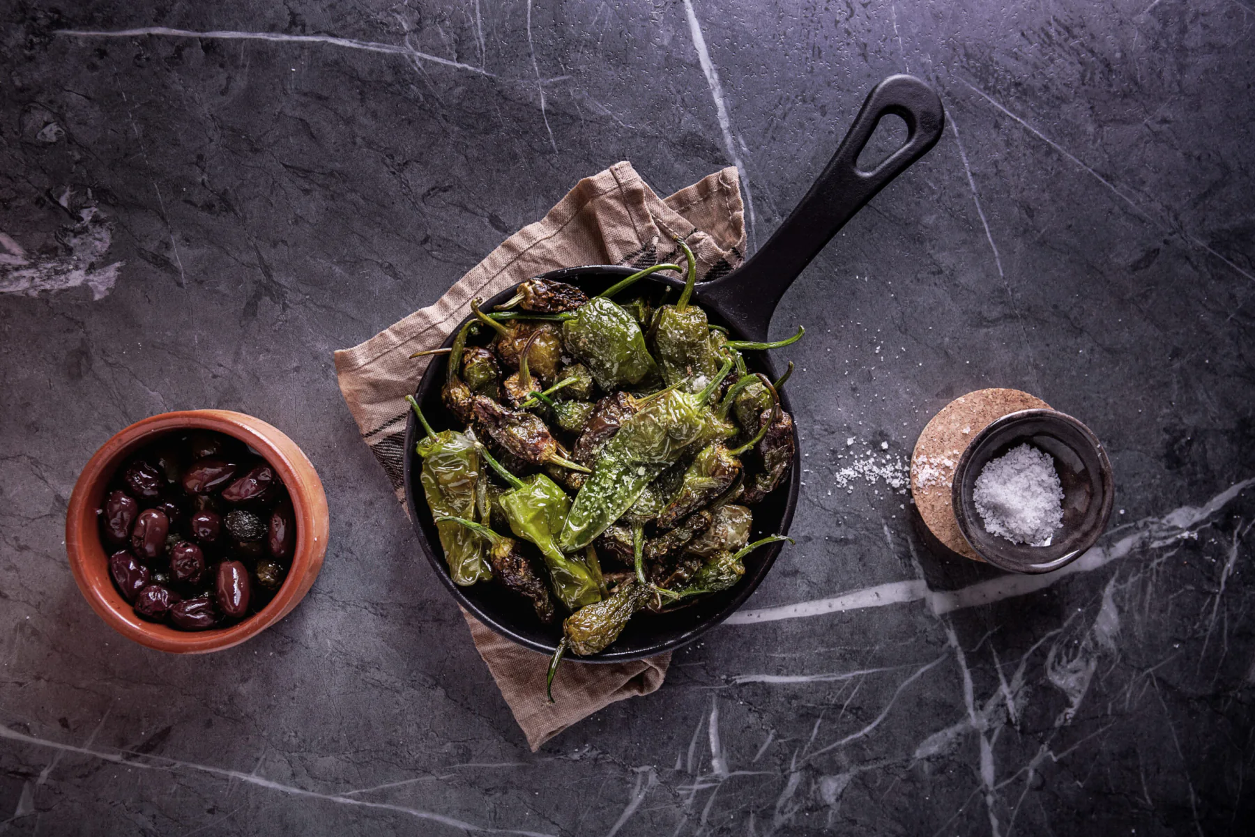 Pimientos de Padrón und Oliven auf der Speisekarte von Tapas & More